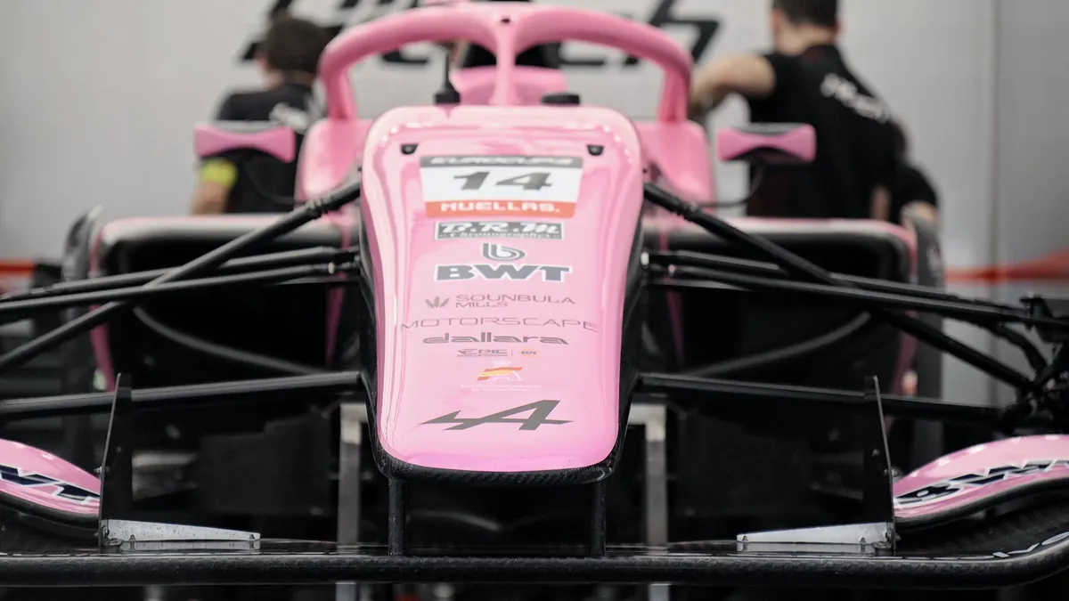 The nose of a pink single-seater in its garage
