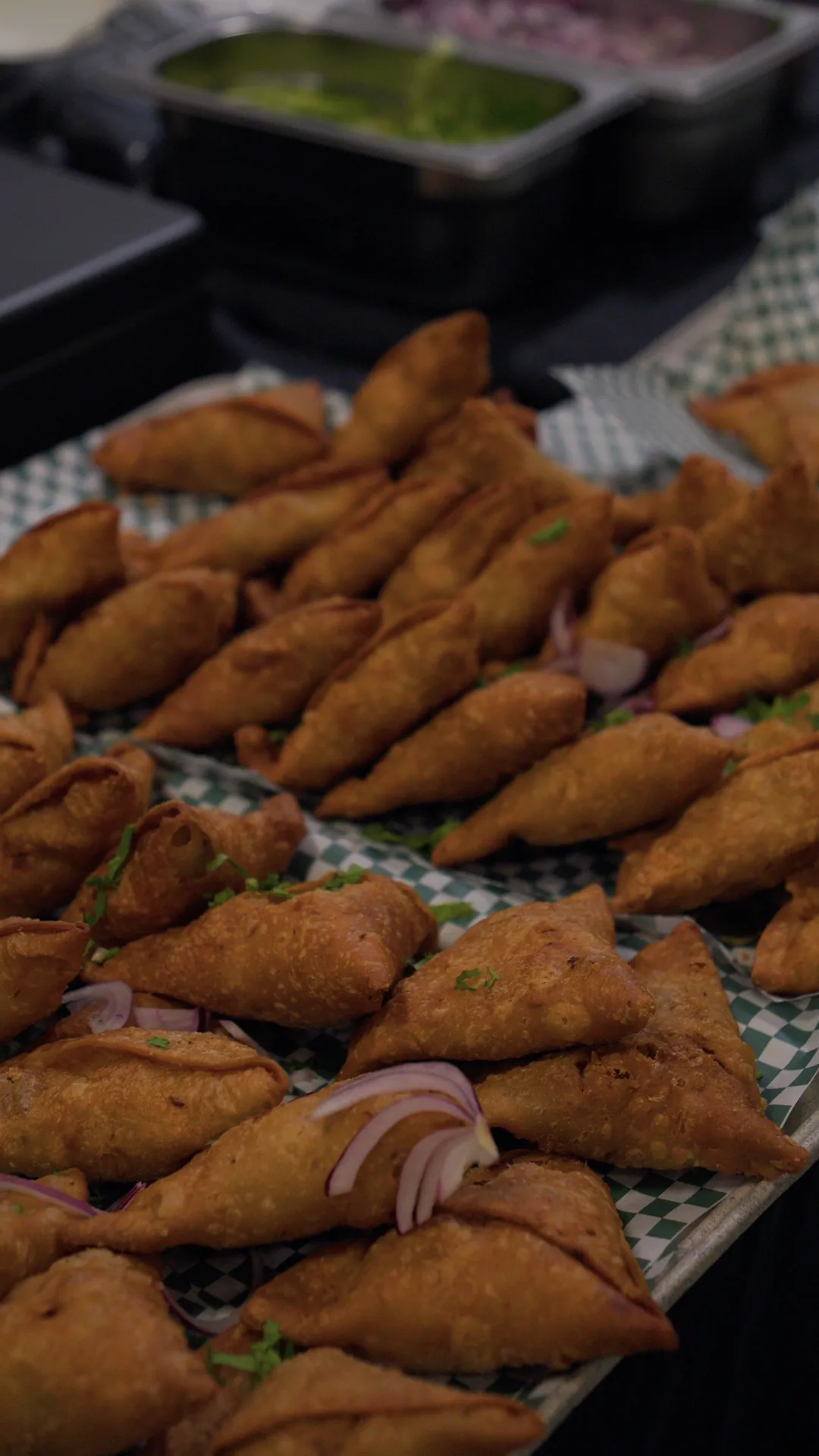 A tray of samosas on a food stall