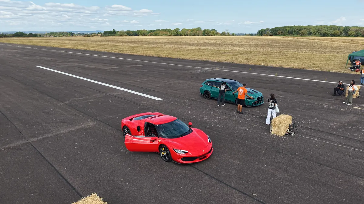 Cars lining up for a grudge race, seen from the drone