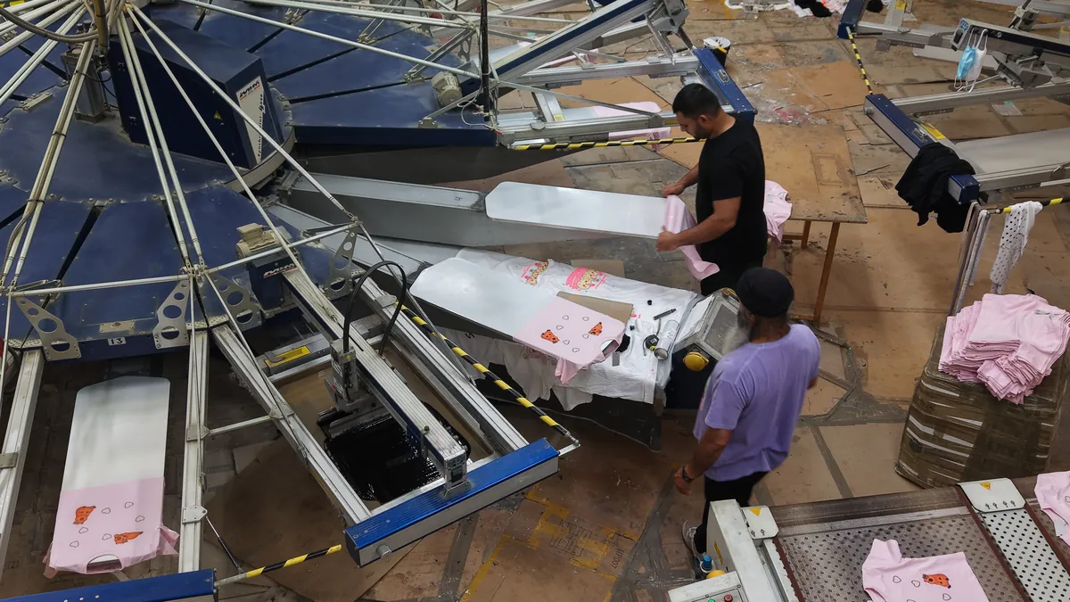 The carousel press from above, with the printers loading garments