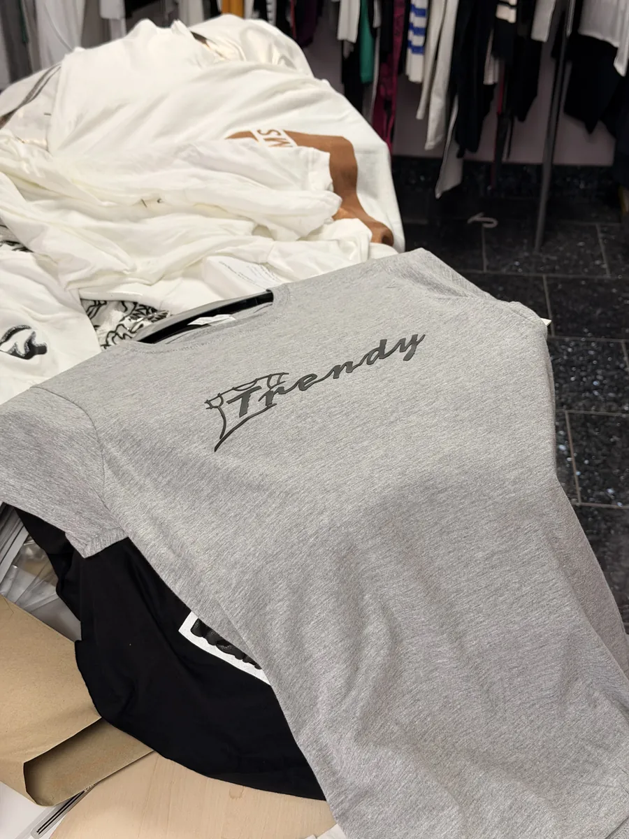 Freshly printed t-shirts on a rail